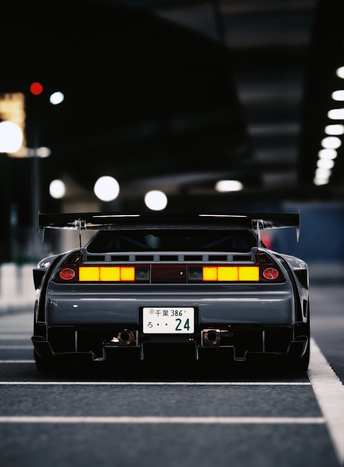 services-04 Rear view of a JDM sports car with bodykit at night in Japan.